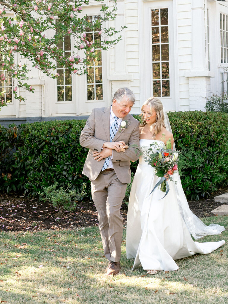 father and bride walking down the aise looking at each other having a moment at payne corley house.