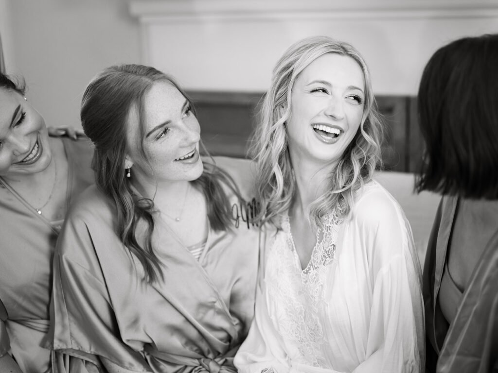 bridesmaids smiling and laughing together at the payne corley house during bridal suite getting ready.
