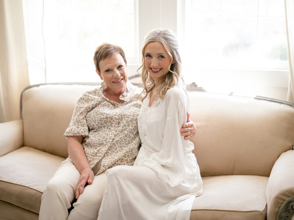 bride and mother of the groom sitting on a bright spot in the payne corley house